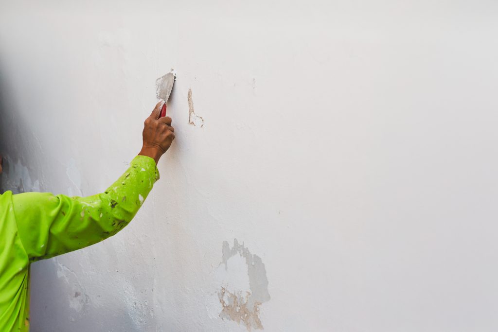 Constantia home with damp boundary wall and timber features being prepared before repainting