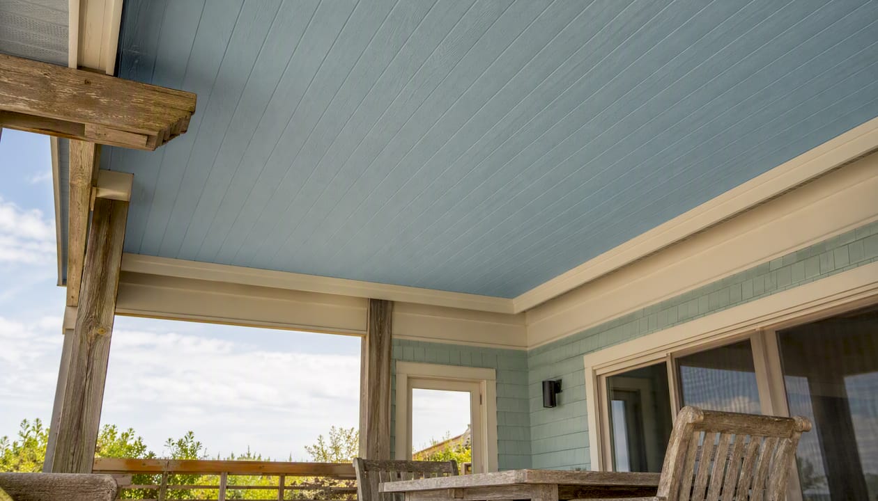 Pale blue coastal porch ceiling with warm white trim
