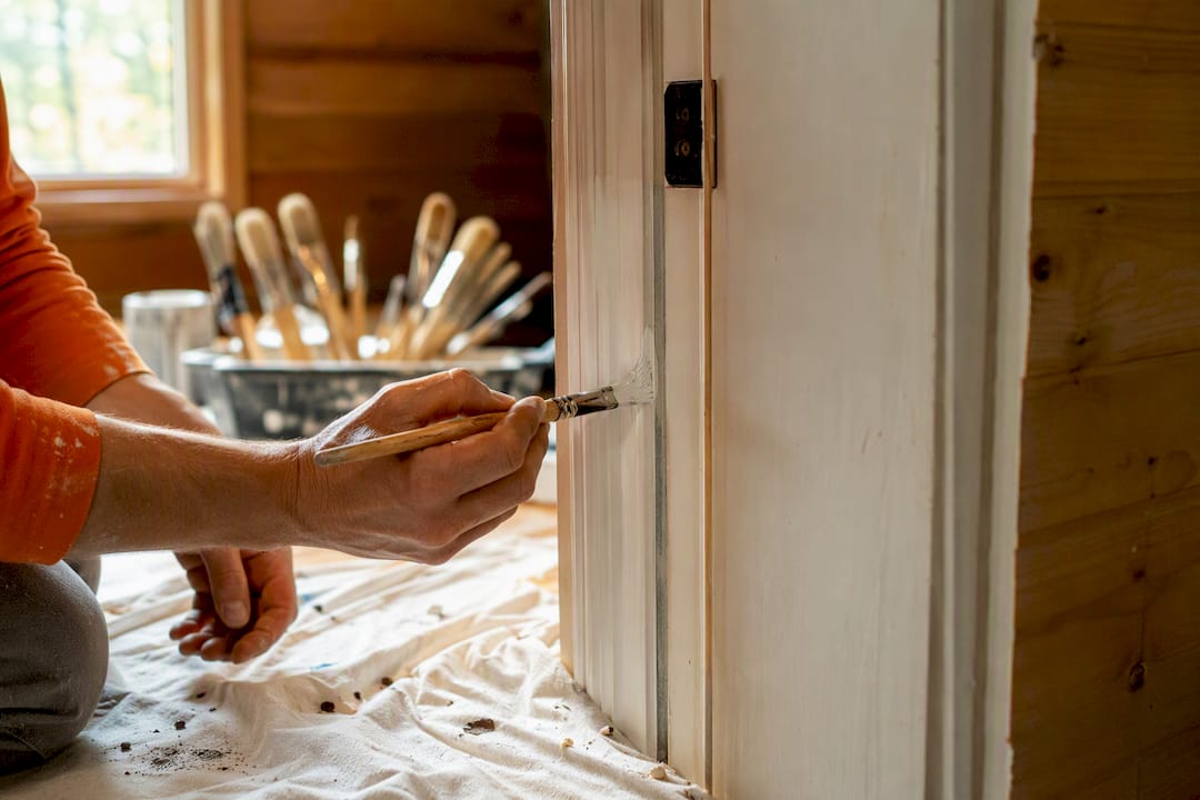 Painter cutting in trim with fine brush